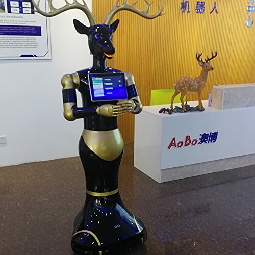 Robot with deer antlers holding a tablet in an office setting.